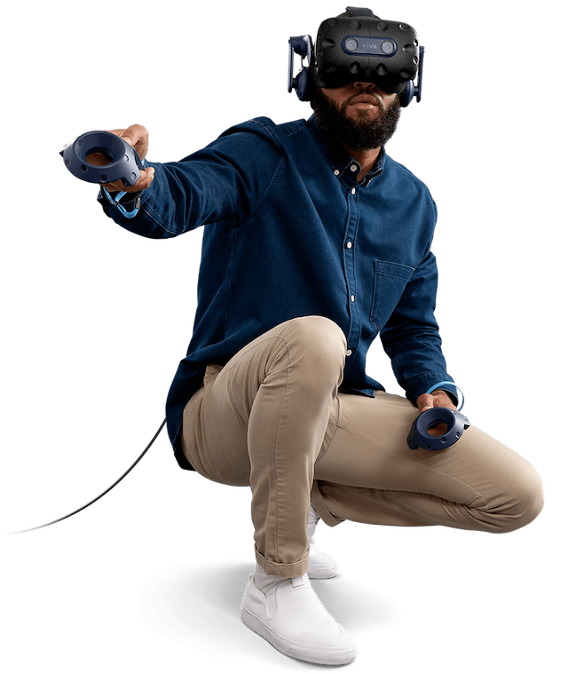A man wearing a VIVE Pro 2 headset crouching while holding two VIVE Pro 2 controllers
